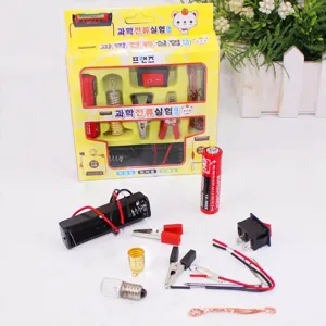 Detailed view of electrical components like battery holder and bulb for DIY science experiments.