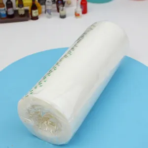 Close-up detail shot of white invisible adhesive tape roll wrapped in transparent plastic film.