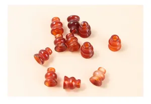 Macro view of several natural red agate gourd-shaped loose beads for DIY jewelry making crafts
