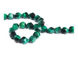 Macro view of faceted green tiger eye beads showing detailed stone texture and luster.