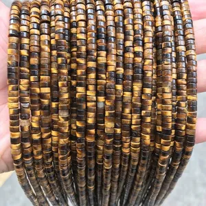 Macro detail view of 2x4mm natural tiger eye stone flat disc beads for DIY jewelry making
