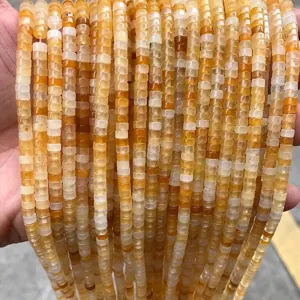 Macro view of natural yellow jade 2x4mm square spacer beads for DIY jewelry making.
