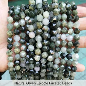 Macro view of natural green seraphinite stone faceted rhombic beads for DIY jewelry making