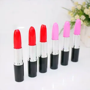 Row of creative lipstick-shaped ballpoint pens in vibrant red and pink colors