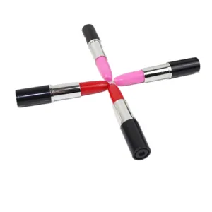 Detailed view of colorful ballpoint pens designed like lipsticks in red and pink
