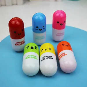 Close-up of colorful capsule-shaped ballpoint pens with cute cartoon facial expressions