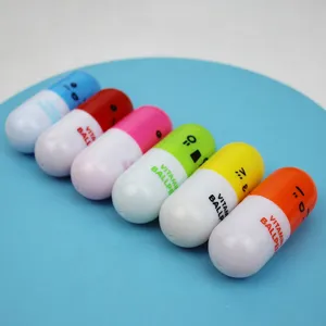 Macro view of colorful retractable capsule-shaped ballpoint pens with smiley faces