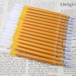 Close-up detail of glittering gold pen refills for sutra copying