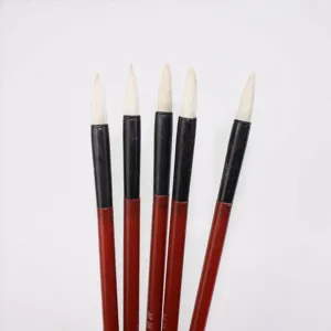 Detailed view of traditional Chinese calligraphy brushes set with fine white hair and red handles.
