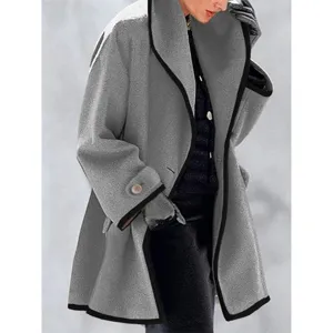 Elegant detail view of a women's oversized grey wool-like coat with black contrast trim