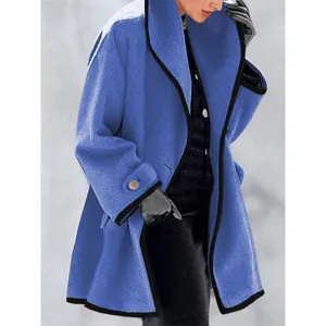 Detailed view of women's bright blue wool coat with black contrast piping and cuff button.