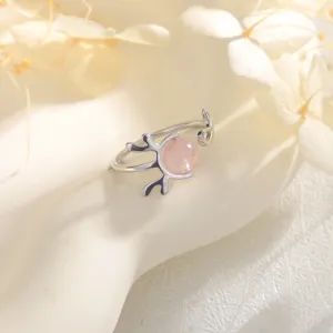 Detailed close-up of an elegant antler design ring with a pink strawberry quartz bead.