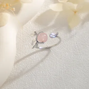 Close-up view of elegant silver antler design ring with pink strawberry quartz bead