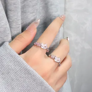 Detailed view of cute cat shaped silver rings with sparkling pink zircons on hand