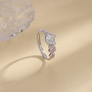Close-up of silver cat ring with pink heart zircon and paw prints