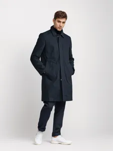 Detailed view of men's solid color mid-length trench coat featuring a classic lapel design.