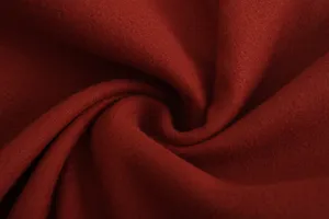 Gros plan sur la texture macro d'un tissu de laine bordeaux de qualité supérieure.