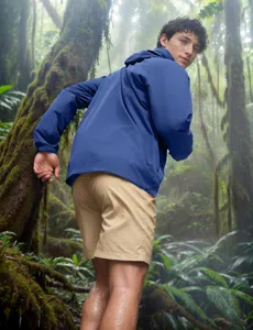 Detailed view of the men's hooded sun protection jacket worn in a vibrant rainforest scene.