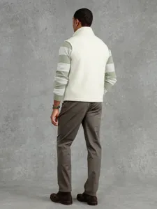 Detailed view of men casual fleece vest worn over striped sweater for stylish autumn layer style.