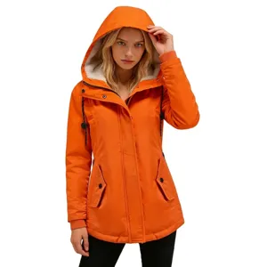 Close-up detail of a vibrant orange women's hooded winter parka with warm fleece lining