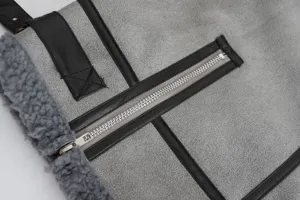 Women's winter shearling jacket detail, grey suede with black leather trim and metal zipper.