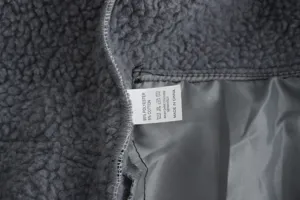 Fleece jacket fabric detail and washing label showing 95% polyester blend material.