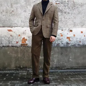 Classic men's houndstooth blazer paired with brown corduroy trousers for a retro vintage style outfit.