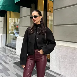 Casual stand collar bomber jacket featuring single-breasted buttons and large front pockets.