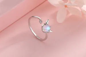 Detailed macro view of silver open ring featuring a cute devil moonstone design