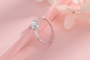 Detailed close-up of a silver moonstone ring with a unique little devil horn design