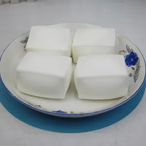 White tofu squishy toy detail view, cute stress relief toy, soft and malleable decompression block.