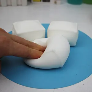 Detail shot of white tofu squeeze toy, showing soft and malleable texture for stress relief.