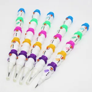 Detailed shot of stackable snowman push pencils, cute cartoon stationery for student learning.