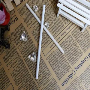 Professional white charcoal sketch pencils for highlighting, shown on vintage newspaper.