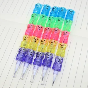 Detailed view of five multi-colored stackable bear-shaped pencils on notebook paper