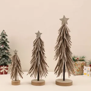 Macro view of three felt Christmas trees with glittery star toppers on wooden bases.