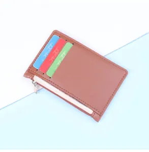 Macro view of slim brown leather card holder featuring three functional colorful card slots.