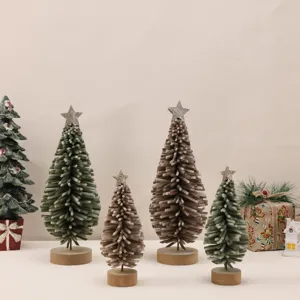 Detailed view of four felt Christmas trees in green and brown with wooden bases