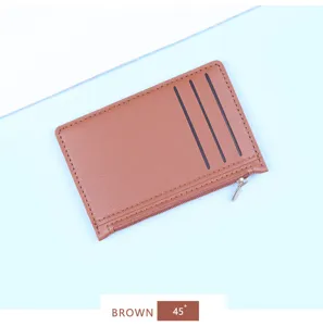 Detailed view of ultra-thin brown leather cardholder featuring three slots and a secure zipper