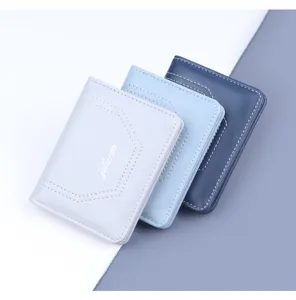 Primer plano de tres carteras de cuero verticales vintage en elegantes tonos azul y gris.
