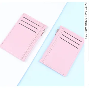Slim pink faux leather card holder with three slots and a functional side zipper.