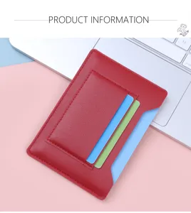Detail view of slim red leather passport and card holder on a modern creative workspace