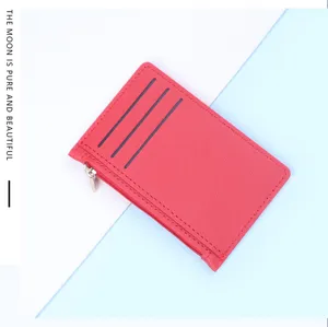 Red slim card holder with zipper and three card slots on a two-tone background