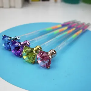 Detailed macro view of creative colorful gel pens featuring large diamond-shaped toppers