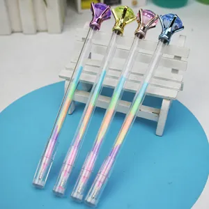 Close-up of four colorful gel pens with large diamond toppers on a mini bench.