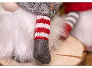 Detaillierte Nahaufnahme des weißen Bartes und der gestrickten Beine einer Weihnachtspuppe