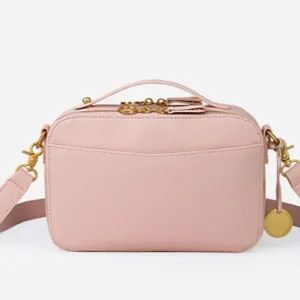 Elegant light pink vintage leather camera bag with double zippers and crossbody strap