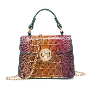 Vintage crocodile embossed crossbody handbag with green top handle and gold chain strap