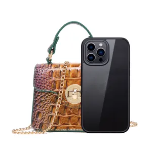 Detailed size comparison of crocodile pattern handbag next to a smartphone