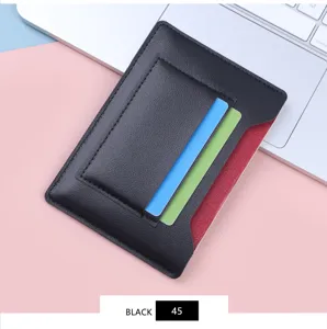 Close-up detail of the slim black leather passport holder featuring multiple card slots